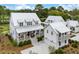 Beautiful two-story home with a metal roof, covered porch, and attached garage at 3023 Eventide Dr, Johns Island, SC 29455