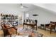 A well-lit home office with wood floors, a large desk, built-in shelves, and comfortable chairs at 3023 Eventide Dr, Johns Island, SC 29455