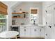 Bright kitchenette with open shelving, mini fridge, and seating area at 3023 Eventide Dr, Johns Island, SC 29455