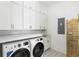 Laundry room featuring modern washer, dryer, ample storage, and stylish patterned tile flooring at 3023 Eventide Dr, Johns Island, SC 29455