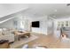Bright and airy living room with hardwood floors, a large sofa, and a rustic wooden coffee table at 3023 Eventide Dr, Johns Island, SC 29455