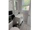 Bright bathroom featuring white vanity, tiled floor, and ample natural light from the window at 304 Carolina Cir, Walterboro, SC 29488