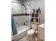 Well-lit bathroom with tiled shower, storage shelves, and contemporary design at 304 Carolina Cir, Walterboro, SC 29488