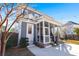 Exterior view of the home featuring a screened porch, lighting, and landscaping at 308 Oak Park St, Summerville, SC 29486