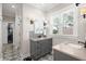 Bathroom featuring dual vanities, patterned floors, and natural lighting at 308 Oak Park St, Summerville, SC 29486