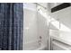 Tiled tub and shower combination in bright bathroom with patterned curtain at 308 Oak Park St, Summerville, SC 29486