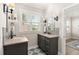 Bathroom featuring dual vanities, patterned floors, and natural lighting at 308 Oak Park St, Summerville, SC 29486