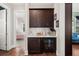 Butler pantry features dark cabinets, beverage cooler and beverage appliances on a white countertop at 308 Oak Park St, Summerville, SC 29486