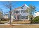 Charming two-story home featuring a manicured lawn and classic American architecture on a sunny day at 308 Oak Park St, Summerville, SC 29486