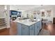 Open-concept kitchen featuring a blue island with marble countertop, and hardwood floors at 308 Oak Park St, Summerville, SC 29486