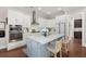 Kitchen boasts white cabinets, stainless steel appliances, marble countertop and hardwood floors at 308 Oak Park St, Summerville, SC 29486