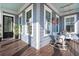 Inviting porch with a hanging swing, white wicker chair, and blue ceiling, perfect for relaxation at 308 Oak Park St, Summerville, SC 29486
