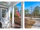 Relaxing porch with a hanging swing, overlooking a serene neighborhood street and lush greenery at 308 Oak Park St, Summerville, SC 29486