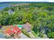 Expansive aerial view showcasing a beautiful home with a pool, complemented by lush greenery and waterfront scenery at 310 Christiee Ct, North Charleston, SC 29418