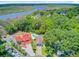 Captivating aerial view featuring a home with a pool near the water, nestled among lush greenery and picturesque surroundings at 310 Christiee Ct, North Charleston, SC 29418