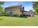 Expansive backyard with lush lawn, mature trees, and patio space for outdoor gatherings at 310 Christiee Ct, North Charleston, SC 29418