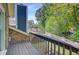 Balcony with wooden railing overlooking the backyard, showcasing the outdoor living space and view at 310 Christiee Ct, North Charleston, SC 29418