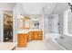 The bathroom features a bathtub, shower, wood cabinets, and ample counter space at 310 Christiee Ct, North Charleston, SC 29418