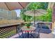Deck with umbrella-covered table and chairs, ideal for outdoor dining and enjoying the surrounding scenery at 310 Christiee Ct, North Charleston, SC 29418