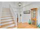 Bright foyer featuring hardwood floors, and a white staircase at 310 Christiee Ct, North Charleston, SC 29418