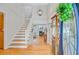 The bright foyer features hardwood floors, stairs, and an elegant chandelier at 310 Christiee Ct, North Charleston, SC 29418