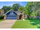 Charming two-story home features a two-car garage and a well-manicured lawn surrounded by mature trees at 310 Christiee Ct, North Charleston, SC 29418