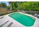 Backyard pool featuring a sun deck and lounge chairs surrounded by a privacy fence and lush greenery at 310 Christiee Ct, North Charleston, SC 29418