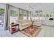 Bright sunroom with large windows, neutral decor, and a charming rug at 310 Christiee Ct, North Charleston, SC 29418
