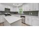 Updated kitchen featuring stainless appliances, white cabinets, and an island with quartz countertops at 3231 Stonehaven Dr, North Charleston, SC 29420