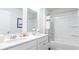 A stylish bathroom features double sinks with quartz countertops and a bathtub-shower combo at 325 Willow Run Dr, Summerville, SC 29486