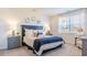 Cozy bedroom with a large window, plush bedding, and elegant bedside tables at 325 Willow Run Dr, Summerville, SC 29486
