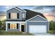 Charming two-story home with a two-car garage, black shutters, and a well-manicured lawn at 325 Willow Run Dr, Summerville, SC 29486