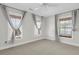 Bright bedroom featuring three windows with cloth curtains and bamboo blinds, and a ceiling fan at 327 Megans Bay Ln, Charleston, SC 29492