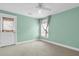 Light and airy bedroom painted pastel green with a door to the outside and a window with bamboo blinds at 327 Megans Bay Ln, Charleston, SC 29492