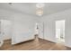 Bright bedroom with hardwood floors, modern light fixture, built-in storage, and convenient access to the bathroom at 327 Megans Bay Ln, Charleston, SC 29492