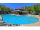 Large outdoor pool with lounge chairs and covered pavilion, surrounded by lush greenery at 327 Megans Bay Ln, Charleston, SC 29492