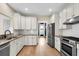 Well-equipped kitchen featuring white cabinets, stainless steel appliances, and granite countertops, ready for cooking at 327 Megans Bay Ln, Charleston, SC 29492