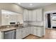 Modern kitchen with stainless steel appliances, granite countertops, and white cabinets, perfect for culinary enthusiasts at 327 Megans Bay Ln, Charleston, SC 29492