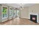 Bright, airy living room featuring large windows, fireplace, and contemporary lighting, offering ample natural light at 327 Megans Bay Ln, Charleston, SC 29492