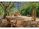 Community playground shaded by a large tree with play structure and picnic bench at 327 Megans Bay Ln, Charleston, SC 29492