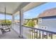 Charming porch with a swing, offering a relaxing outdoor space with a view of the neighborhood at 327 Megans Bay Ln, Charleston, SC 29492
