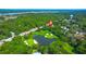 Stunning aerial view of a home overlooking a golf course, lake, and wooded landscape at 3285 Johnstowne St, Johns Island, SC 29455