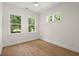 Bedroom with two large windows offering plenty of natural light and hardwood floors at 3285 Johnstowne St, Johns Island, SC 29455