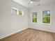 A simple bedroom featuring large windows, hardwood floors and ample natural light at 3285 Johnstowne St, Johns Island, SC 29455