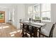 Sunlit dining area with a wooden table, bench seating, and large windows at 3285 Johnstowne St, Johns Island, SC 29455