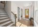 Bright foyer featuring hardwood floors, staircase, and a wooden front door at 3285 Johnstowne St, Johns Island, SC 29455
