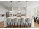A kitchen with a center island, bar stools, and three pendant lights at 3285 Johnstowne St, Johns Island, SC 29455
