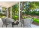 Inviting covered porch with seating area overlooking a beautifully landscaped yard at 3285 Johnstowne St, Johns Island, SC 29455