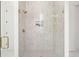 A beautifully tiled shower stall with glass door and bronze fixtures at 3285 Johnstowne St, Johns Island, SC 29455