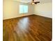 A large bedroom with wood flooring, a ceiling fan, and a big window with lots of natural light at 332 Southern Sugar Ave, Moncks Corner, SC 29461